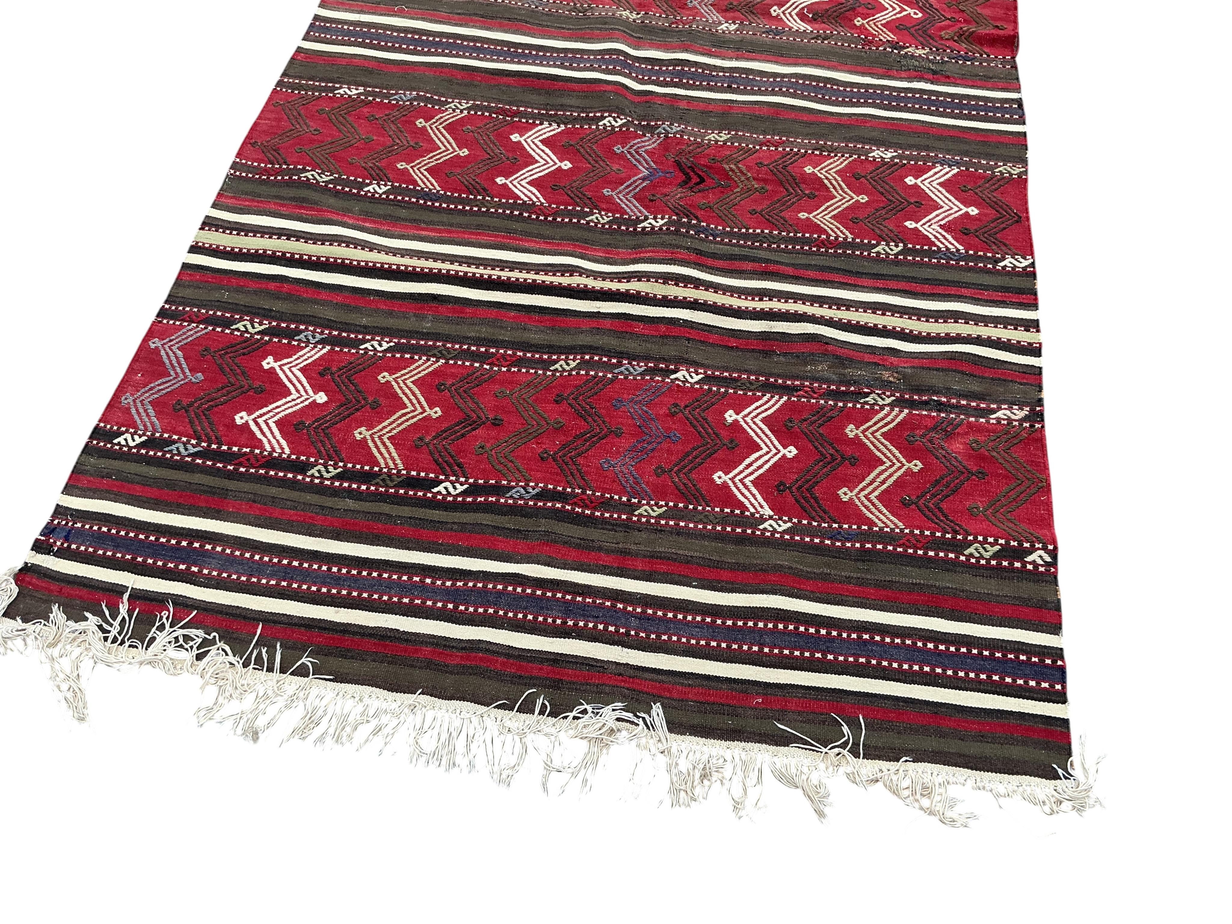 A Turkish kilim flat weave hall carpet, 320 x 140cm